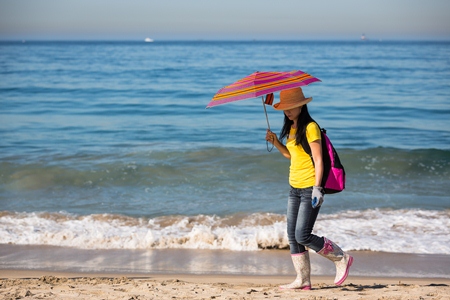 Volunteer combs the sand