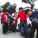 A family cleans up together in South LA at Coastal Cleanup Day on Sept. 17