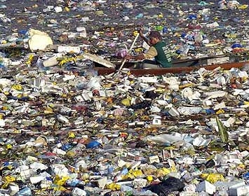 Trash in the L.A. River overwhelms a boater.